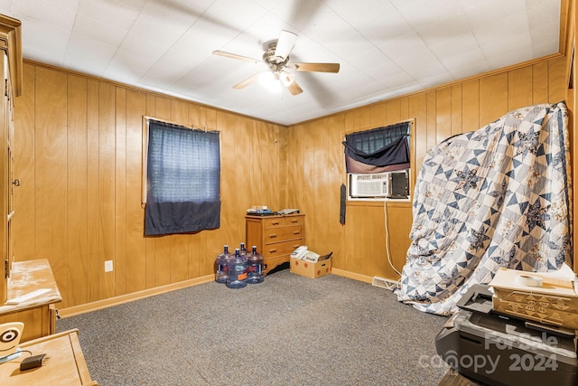 interior space featuring cooling unit, carpet, ceiling fan, and wood walls