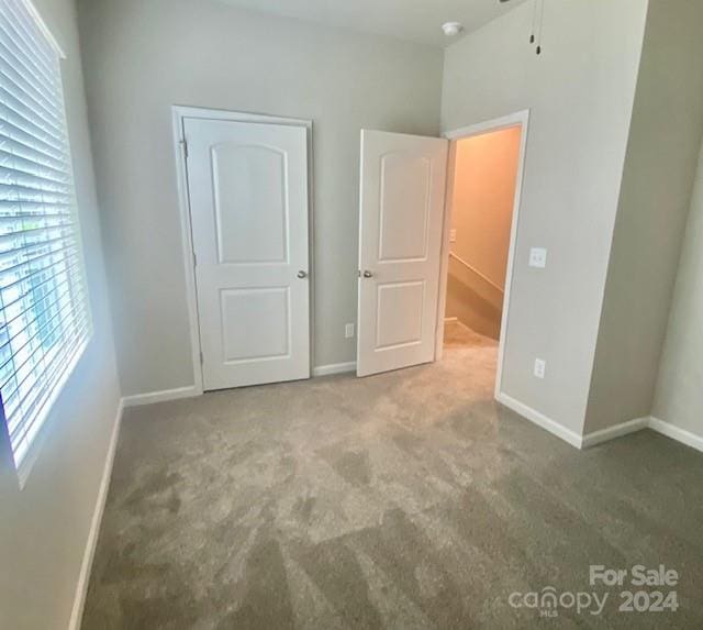 unfurnished bedroom featuring carpet flooring