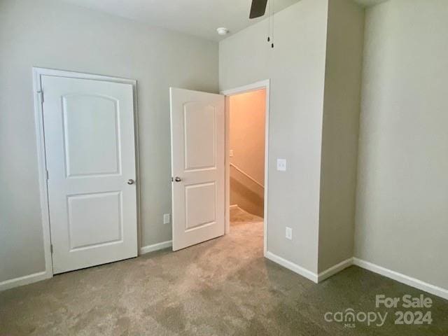 unfurnished bedroom featuring ceiling fan and light colored carpet