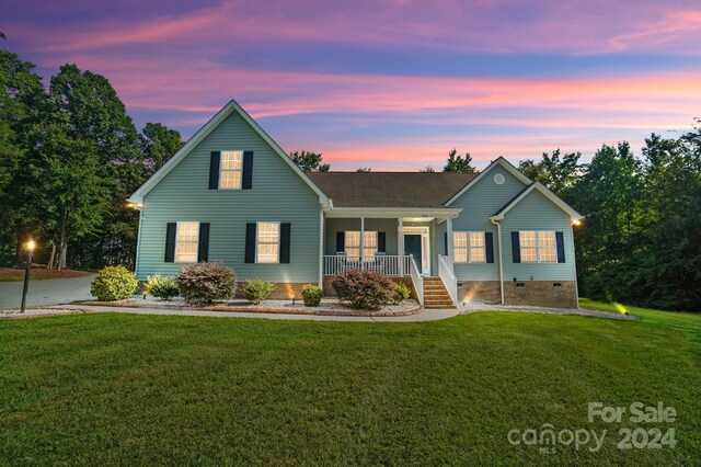 view of front of house featuring a lawn and a porch