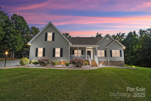 view of front of home featuring a porch, crawl space, and a lawn