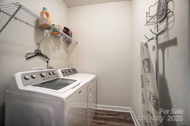 laundry room with dark wood-style floors, washer and dryer, laundry area, and baseboards