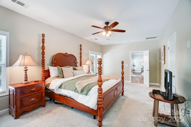 bedroom featuring visible vents, ceiling fan, light carpet, and baseboards