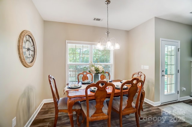 dining area featuring baseboards, dark wood finished floors, visible vents, and an inviting chandelier