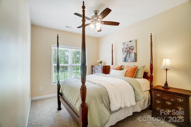 carpeted bedroom with a ceiling fan, visible vents, and baseboards