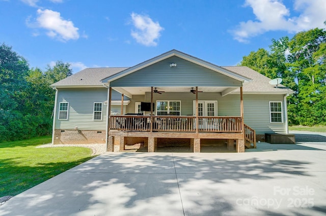 back of house with roof with shingles, a lawn, a ceiling fan, crawl space, and a wooden deck