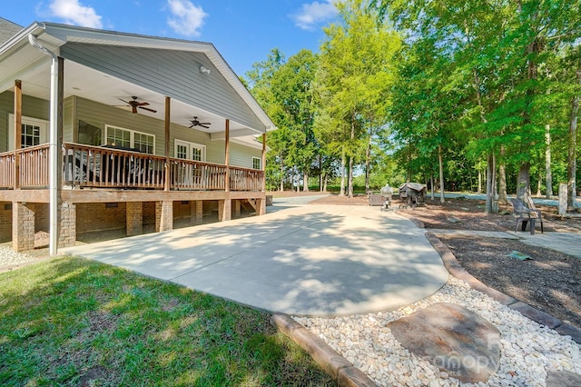 view of side of home with a patio area, ceiling fan, and a deck