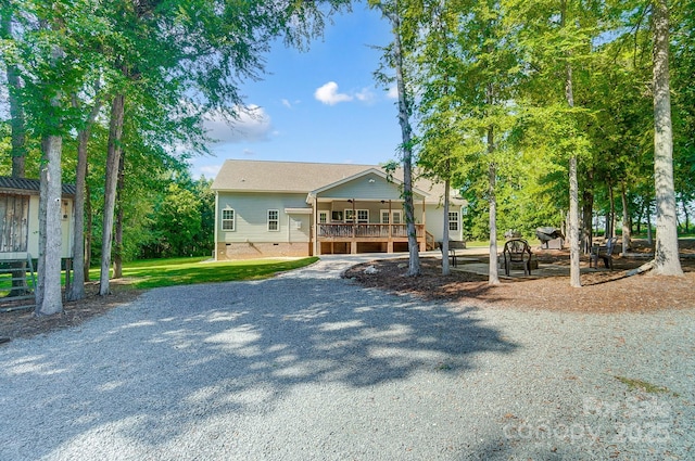 view of front of property featuring driveway and crawl space