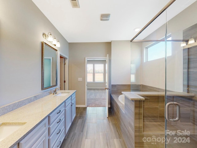 7025 Stella Pl, Stanley, NC 28164 - bathroom featuring double vanity, a bath, and a shower with door