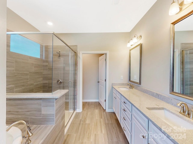 bathroom featuring vanity and a shower with shower door