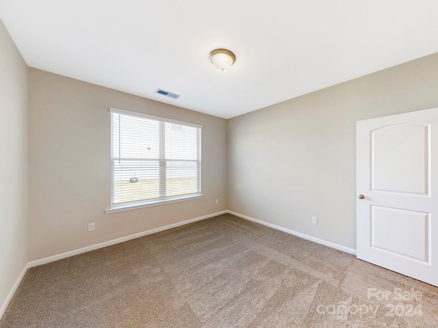 spare room with light colored carpet