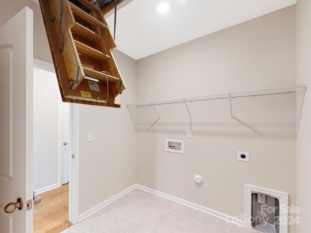 washroom featuring gas dryer hookup, hookup for a washing machine, wood-type flooring, and hookup for an electric dryer