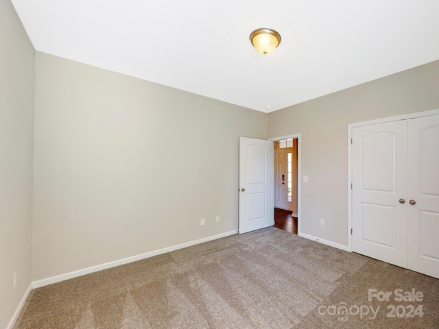 unfurnished bedroom with carpet and a closet