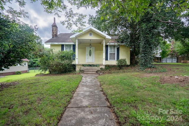 bungalow-style house featuring a porch and a front yard