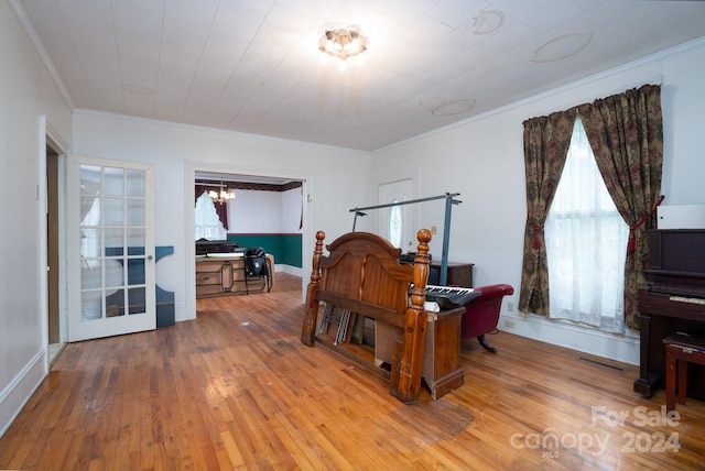 office space featuring light hardwood / wood-style floors, ornamental molding, and a chandelier