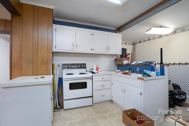 kitchen featuring light tile patterned flooring, white cabinets, electric range, sink, and ornamental molding