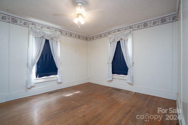 unfurnished room with ceiling fan and hardwood / wood-style floors