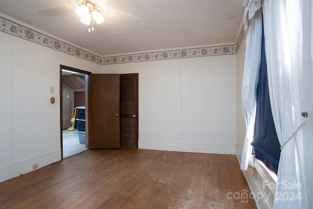 empty room with ceiling fan and wood-type flooring