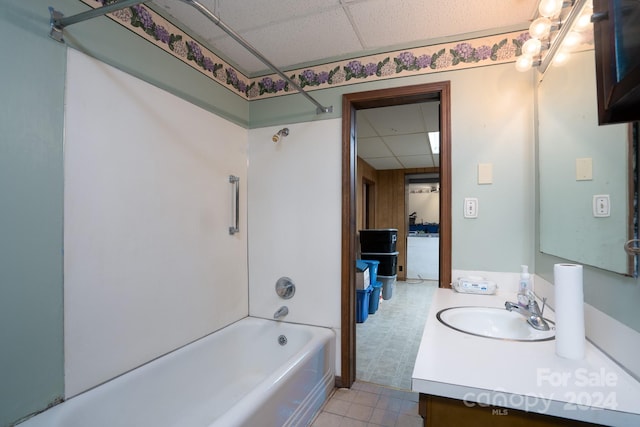 bathroom featuring vanity, shower / washtub combination, a paneled ceiling, and tile patterned floors