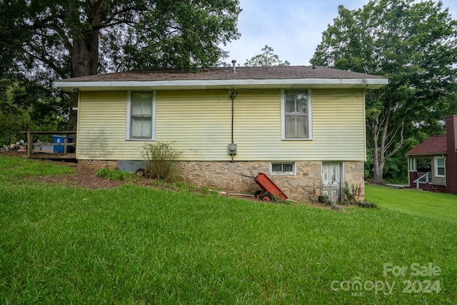 back of property with a lawn