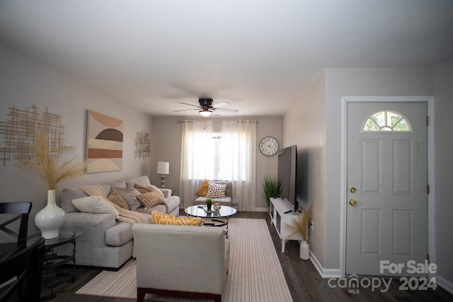 living room featuring wood-type flooring and ceiling fan