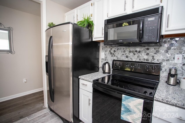 kitchen with black appliances, hardwood / wood-style floors, white cabinets, light stone counters, and decorative backsplash