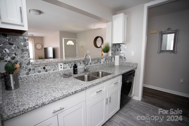 kitchen with sink, dishwasher, tasteful backsplash, and light stone counters