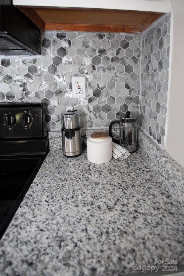 interior details with black range with electric stovetop