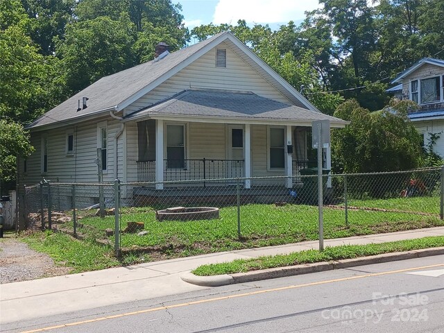 view of front of property with a porch and a front yard