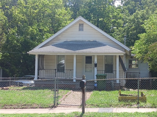 bungalow-style home with covered porch and a front lawn