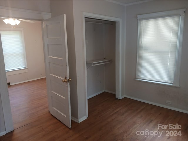 unfurnished bedroom with wood-type flooring and a closet