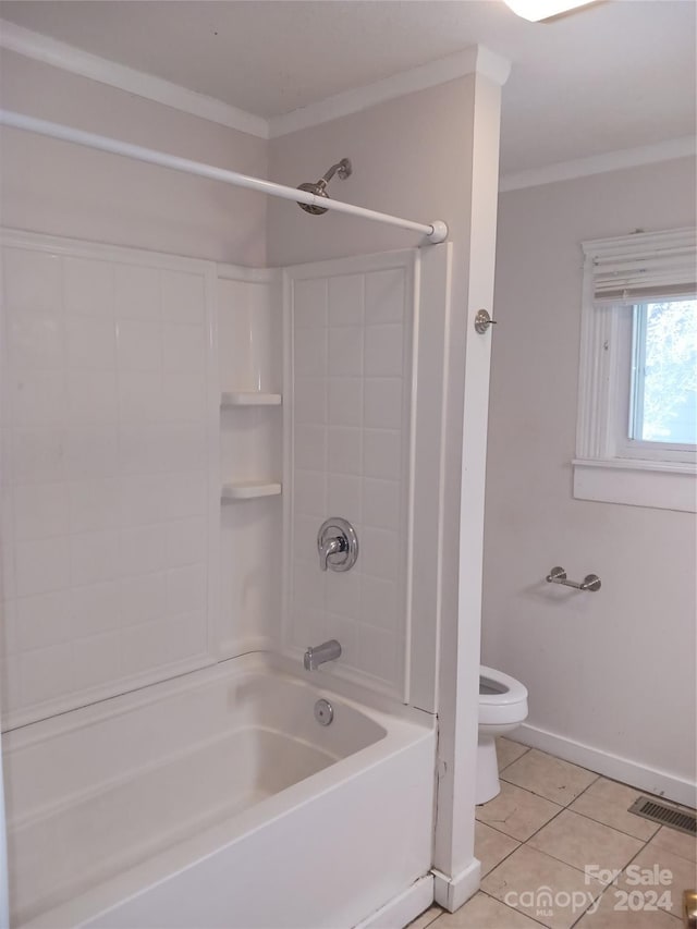 bathroom featuring crown molding, tub / shower combination, tile patterned floors, and toilet