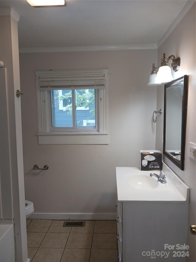 bathroom with crown molding, tile patterned floors, vanity, and toilet