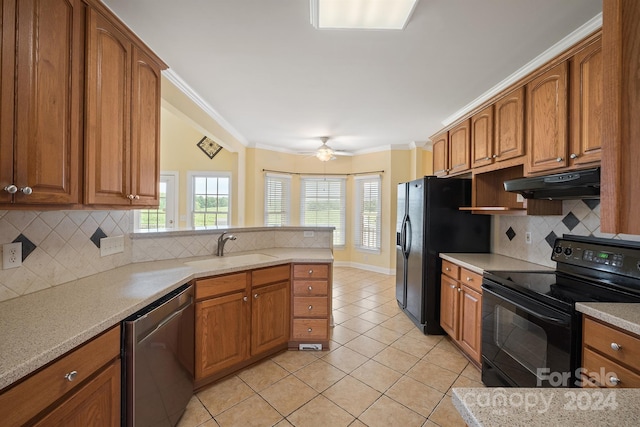 kitchen with under cabinet range hood, a sink, ornamental molding, brown cabinets, and black appliances