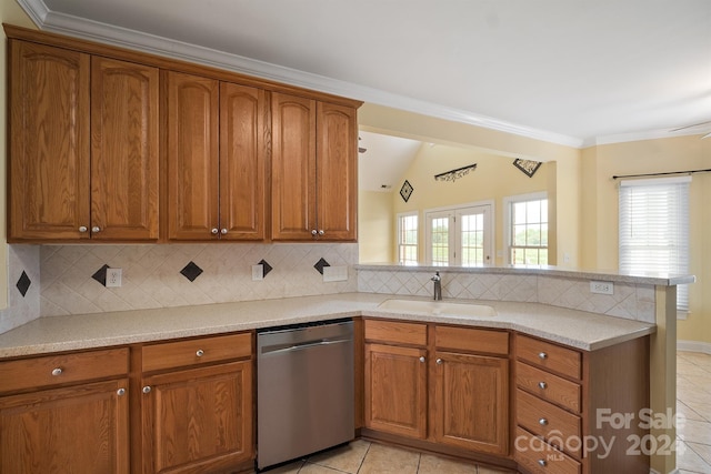 kitchen featuring brown cabinets, dishwasher, a peninsula, and a sink