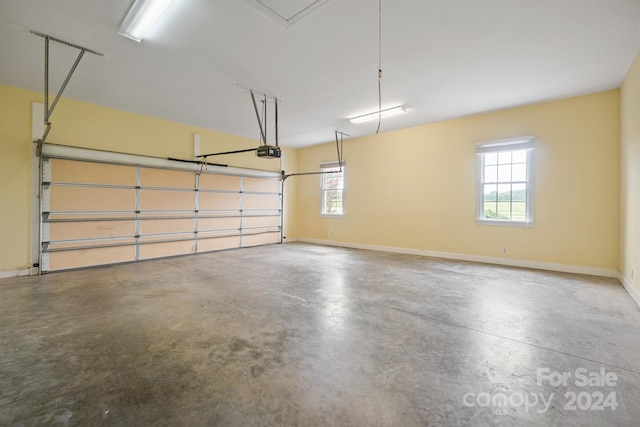 garage with baseboards and a garage door opener