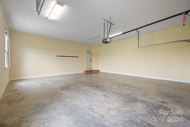 garage featuring baseboards and a garage door opener