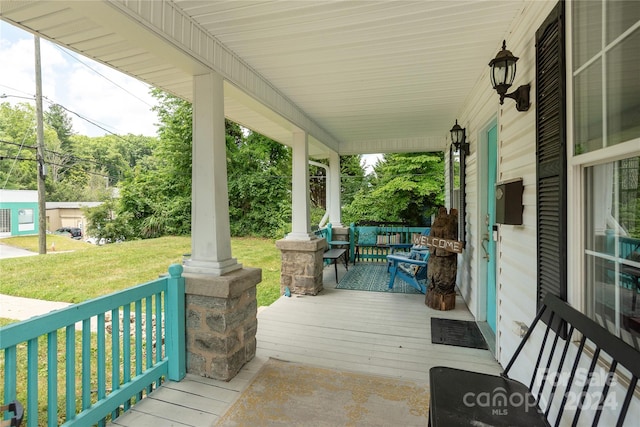 wooden deck featuring a yard