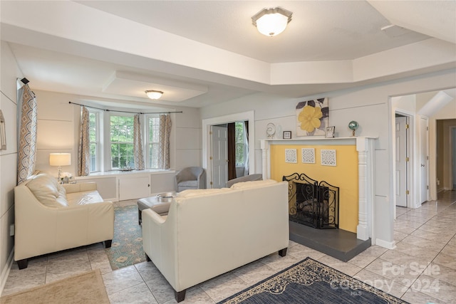 living room featuring light tile patterned floors and a tray ceiling