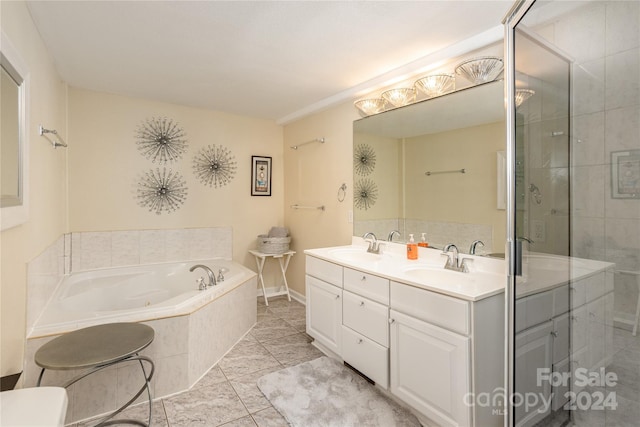 bathroom featuring dual vanity, independent shower and bath, and tile patterned floors