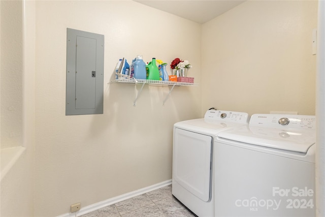 laundry room with separate washer and dryer, electric panel, and light tile patterned floors