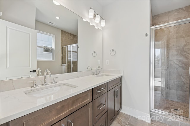 bathroom with tile patterned flooring, vanity, and walk in shower