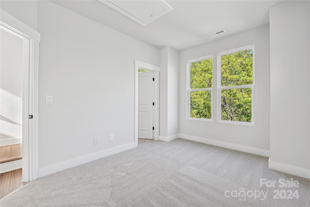 1432 Hamilton St Unit 14, Charlotte, NC 28206 - carpeted spare room featuring attic access and baseboards