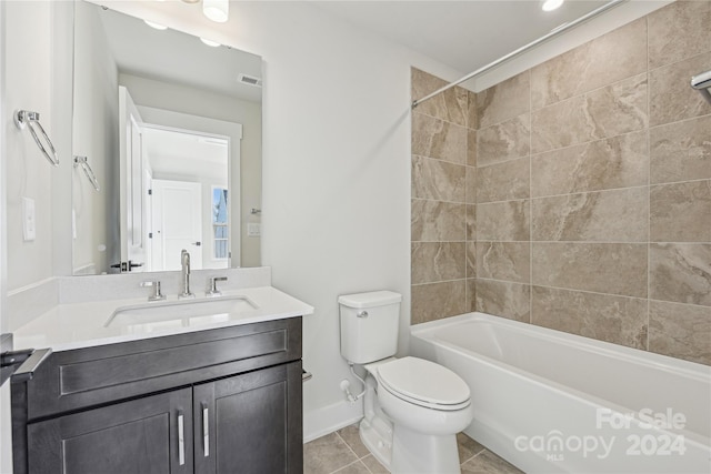 full bathroom featuring tile patterned flooring, tiled shower / bath combo, toilet, and vanity