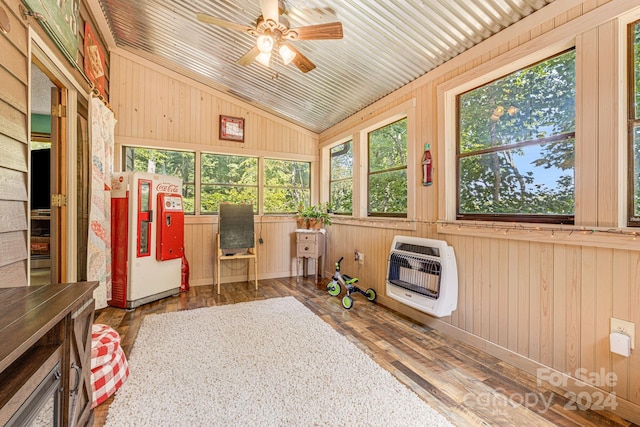 sunroom featuring lofted ceiling, ceiling fan, wood ceiling, and heating unit