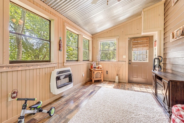 sunroom with vaulted ceiling, heating unit, and ceiling fan