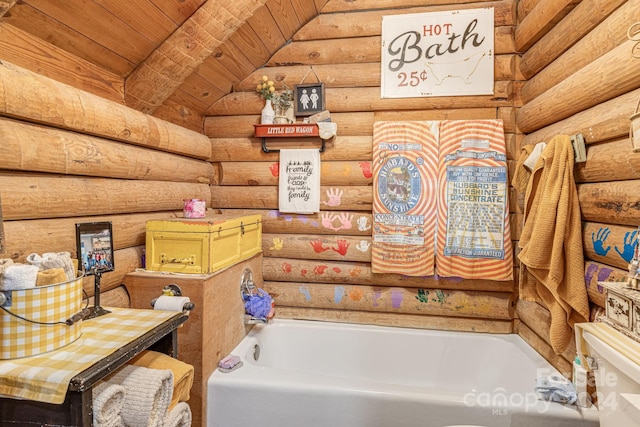 bathroom featuring rustic walls, a bathtub, toilet, and wooden ceiling