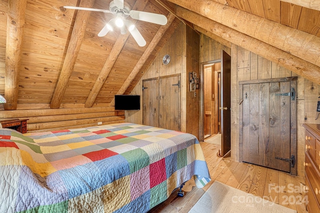 bedroom with wooden ceiling, hardwood / wood-style floors, wooden walls, and vaulted ceiling with beams