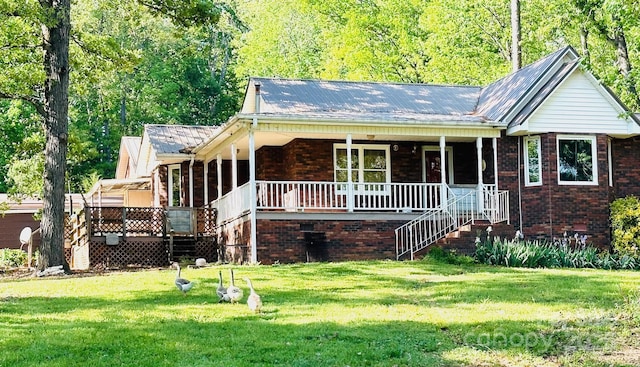 view of front facade featuring a porch, brick siding, a front lawn, and stairs