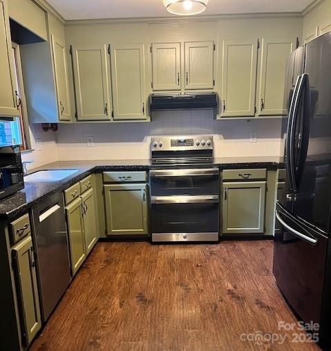 kitchen with appliances with stainless steel finishes, dark hardwood / wood-style flooring, and sink